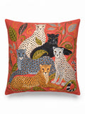 A square decorative throw pillow featuring a colorful illustration of five big cats (leopards, cheetah, black panther, white panthers) surrounded by leaves on a warm red-orange background.